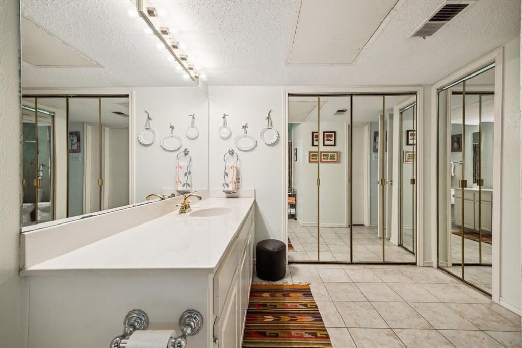 9222 Church Road, Unit 108 Dallas, TX 75231 - Photo 10 of 27 a bathroom with a tub shower and sink
