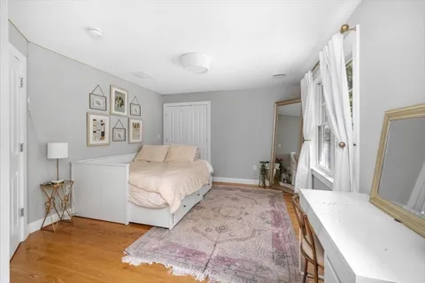 a bedroom with a bed and a bookshelf