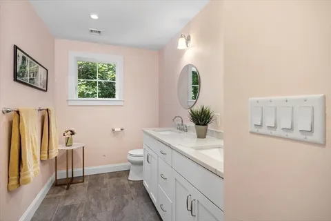 a bathroom with a granite countertop sink and a mirror