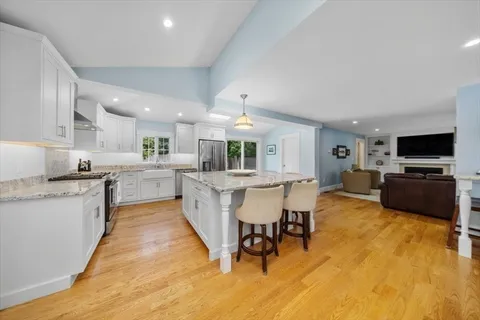a large white kitchen with a table and chairs in it