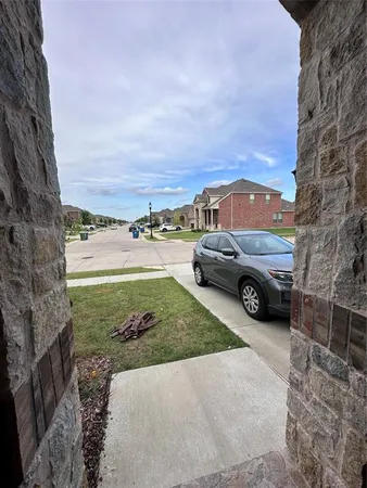 a view of a yard with cars parked