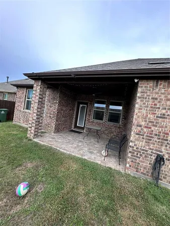 a backyard of a house with table and chairs