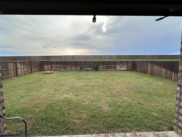 a view of a swimming pool with an outdoor seating and a yard