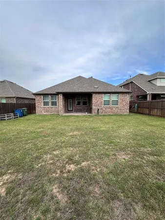 a view of a house with a yard and sitting area