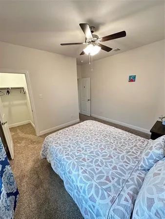 a bedroom with a bed and a mirror
