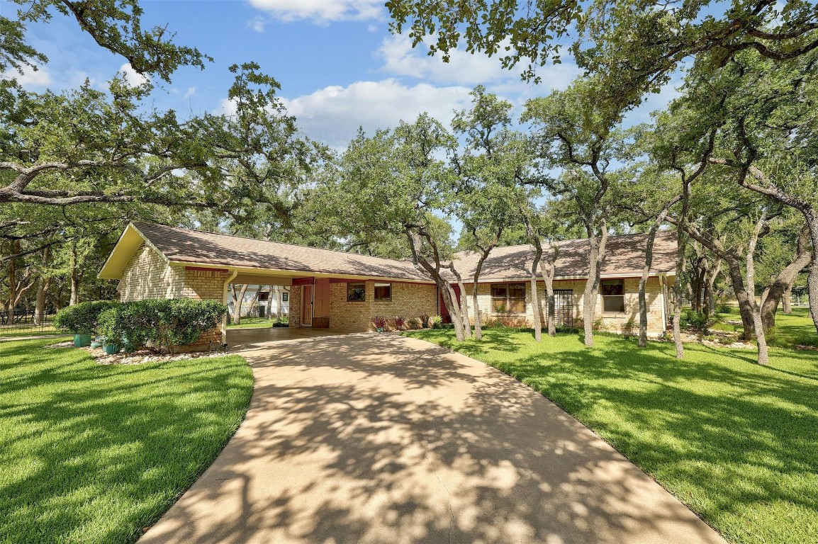 a front view of a house with a garden