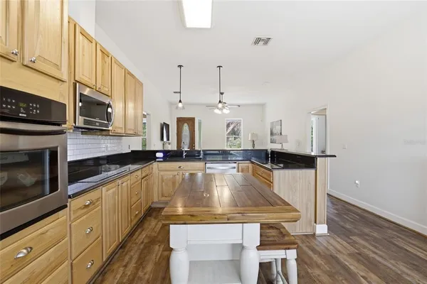 a kitchen with stainless steel appliances a stove sink and cabinets
