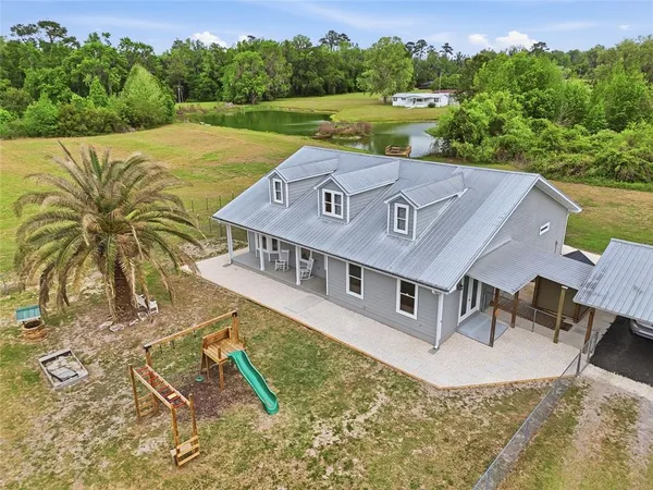 an aerial view of a house with a yard