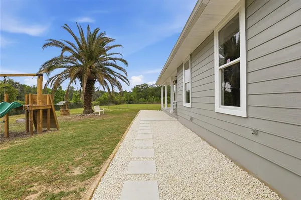 a front view of a house with a garden