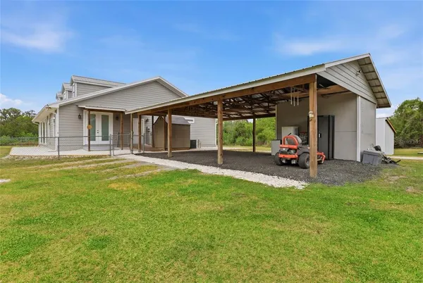 a view of a house with a backyard and a patio