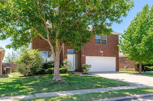 front view of a house with a tree