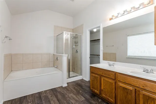 a bathroom with a bathtub shower sink and mirror