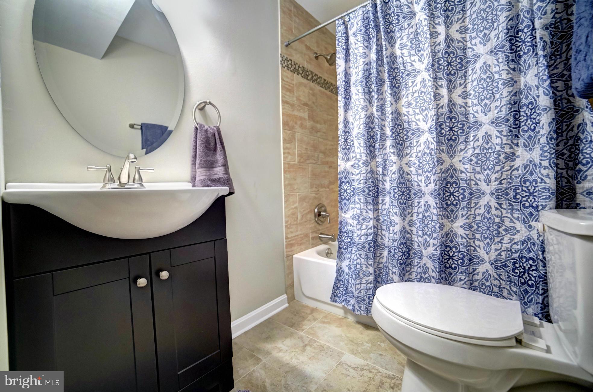 3811 Longley Road Abingdon, MD 21009 - Photo 16 of 21 a bathroom with a sink a toilet and shower curtain