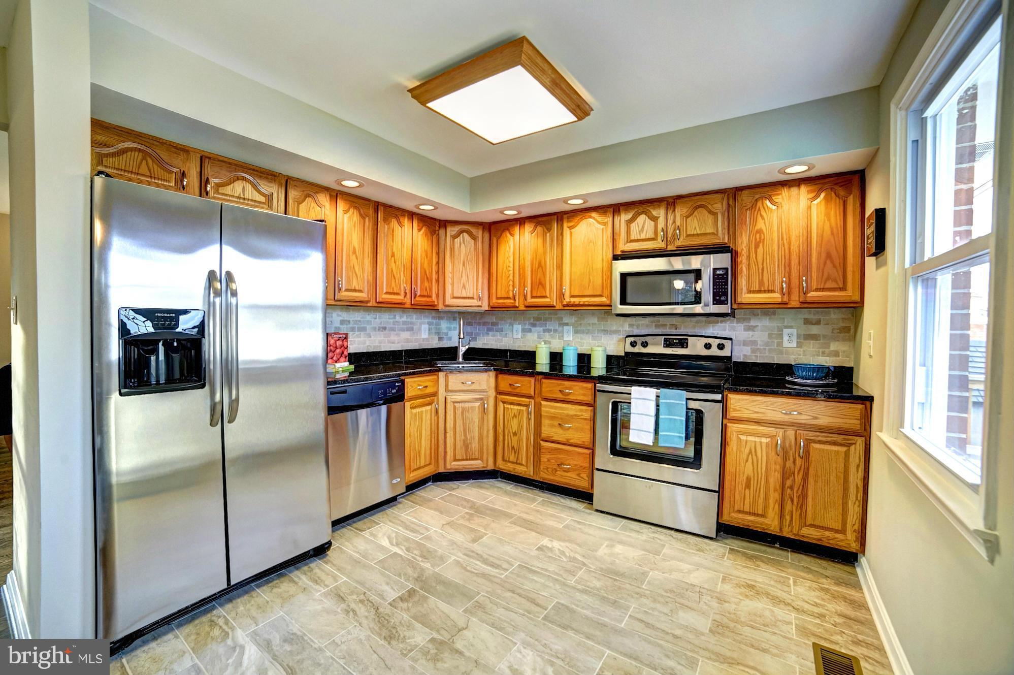 3811 Longley Road Abingdon, MD 21009 - Photo 6 of 21 a kitchen with stainless steel appliances granite countertop a refrigerator and a stove top oven