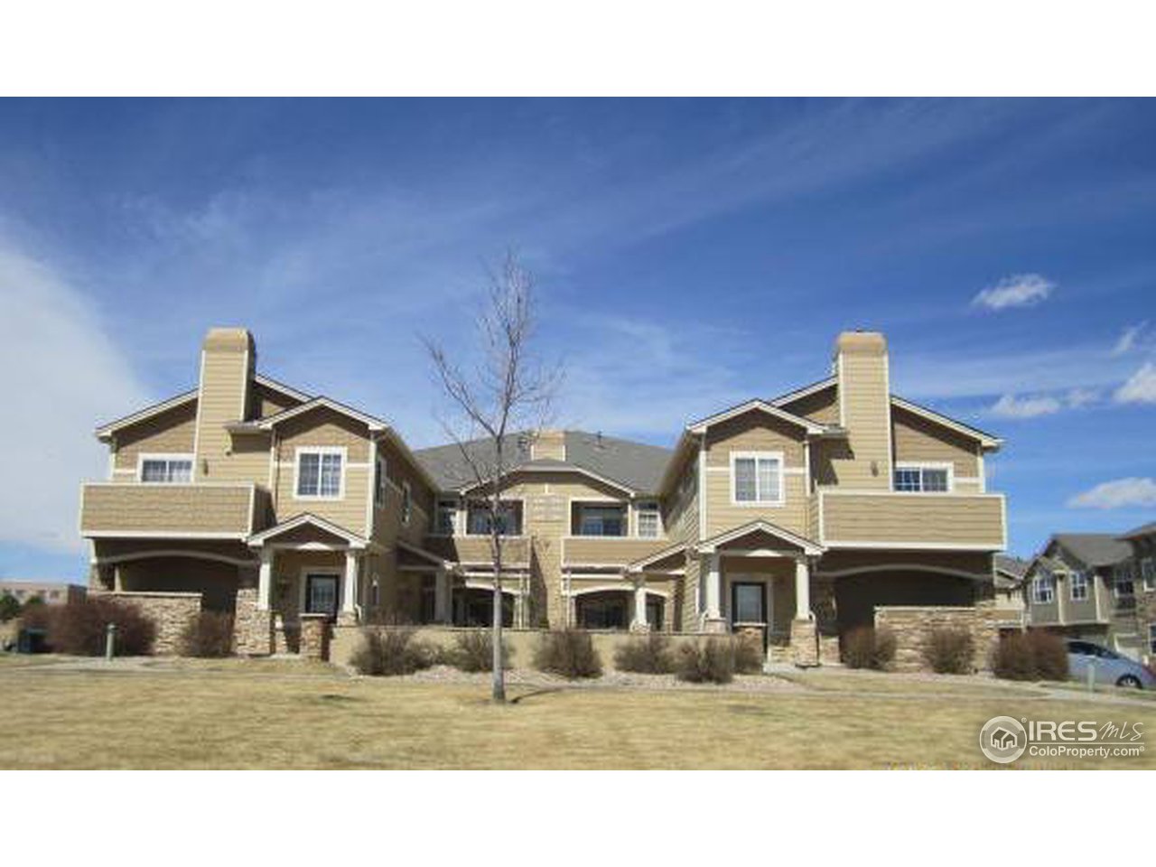 6607 West 3rd Street, Unit 1202 Greeley, CO 80634 - Photo 1 of 14 a front view of a house with a yard