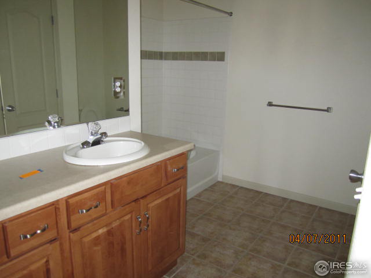 6607 West 3rd Street, Unit 1202 Greeley, CO 80634 - Photo 13 of 14 a bathroom with a sink and a mirror
