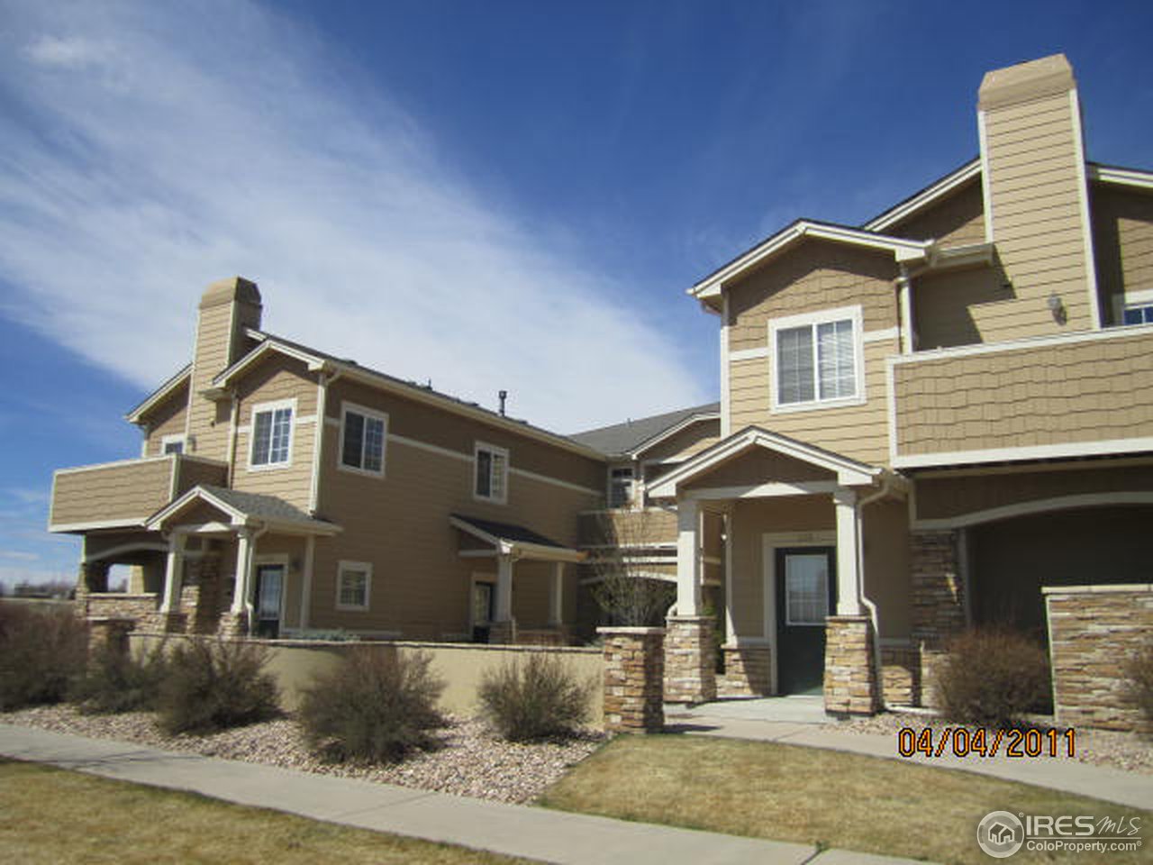 6607 West 3rd Street, Unit 1202 Greeley, CO 80634 - Photo 2 of 14 a front view of a house with a yard