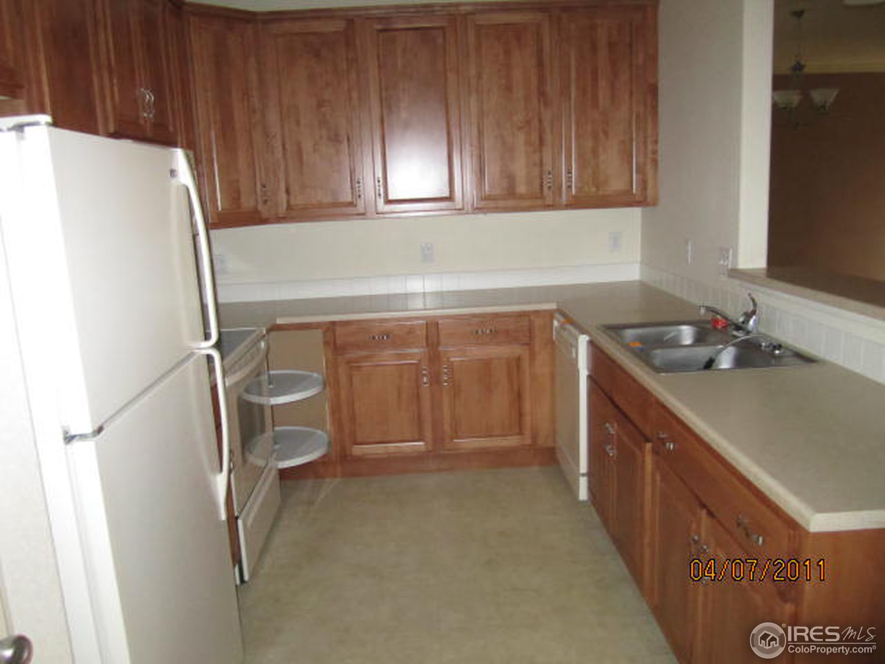 6607 West 3rd Street, Unit 1202 Greeley, CO 80634 - Photo 7 of 14 a kitchen with a sink and a refrigerator