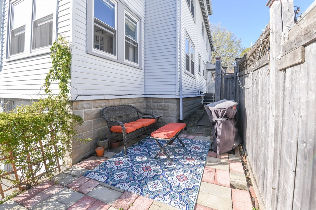 27 Fuller Road, Unit 27 Watertown, MA 02472 - Photo 12 of 13 a view of a chairs and table in the back yard of the house