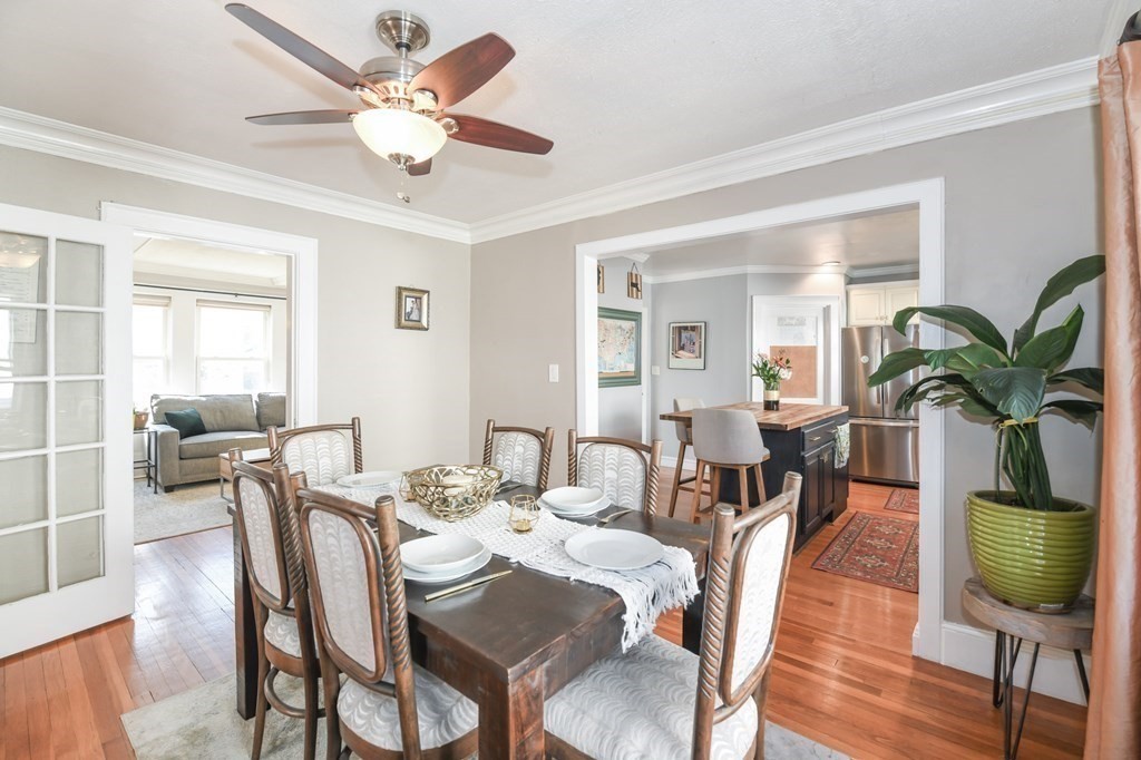 27 Fuller Road, Unit 27 Watertown, MA 02472 - Photo 7 of 13 a view of a dining room with furniture a chandelier and wooden floor