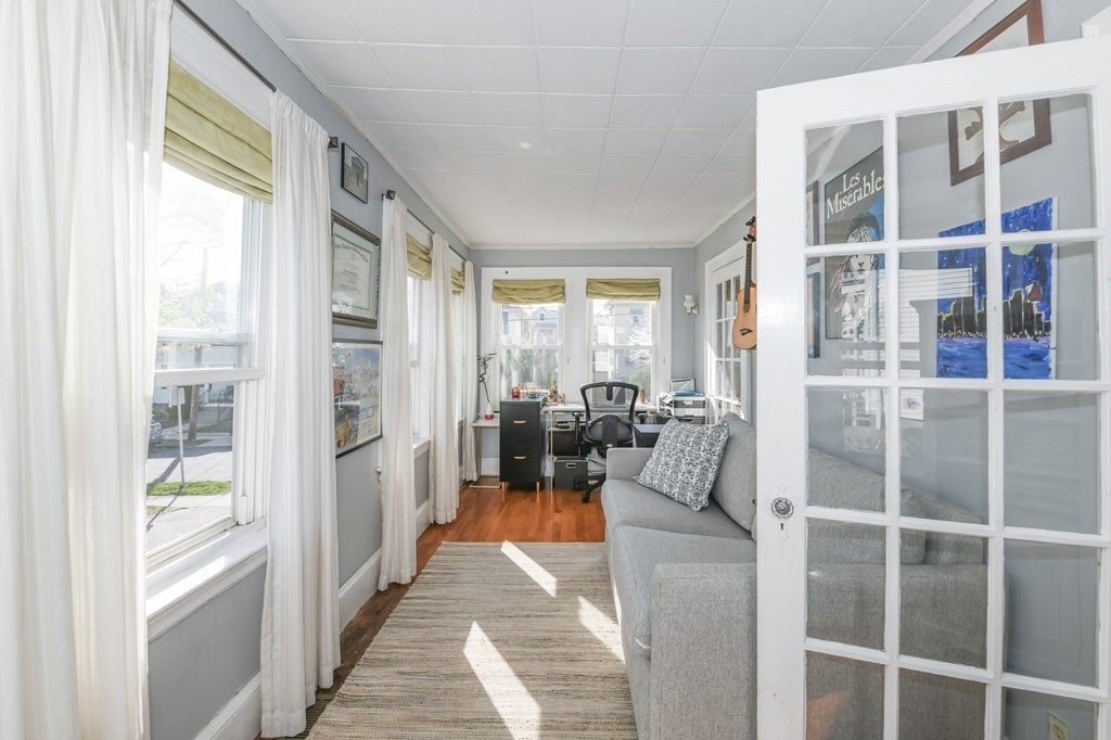 27 Fuller Road, Unit 27 Watertown, MA 02472 - Photo 8 of 13 a hallway with a couch and large windows