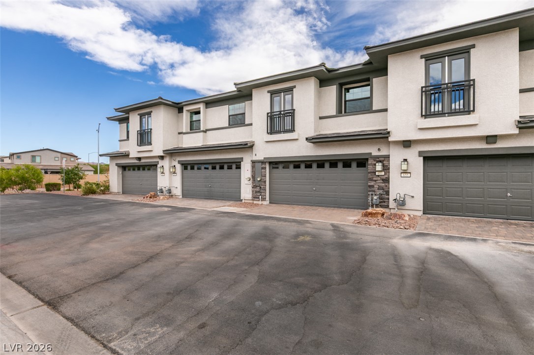 653 Pickled Pepper Place Henderson, NV 89011 - Photo 31 of 35 These modern townhomes feature contemporary architecture with attached garages and balconies.