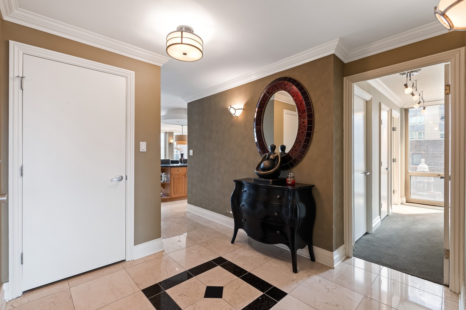 111 East Chestnut Street, Unit 25K Chicago, IL 60611 - Photo 2 of 28 a view of a hallway with entryway wooden floor and front door