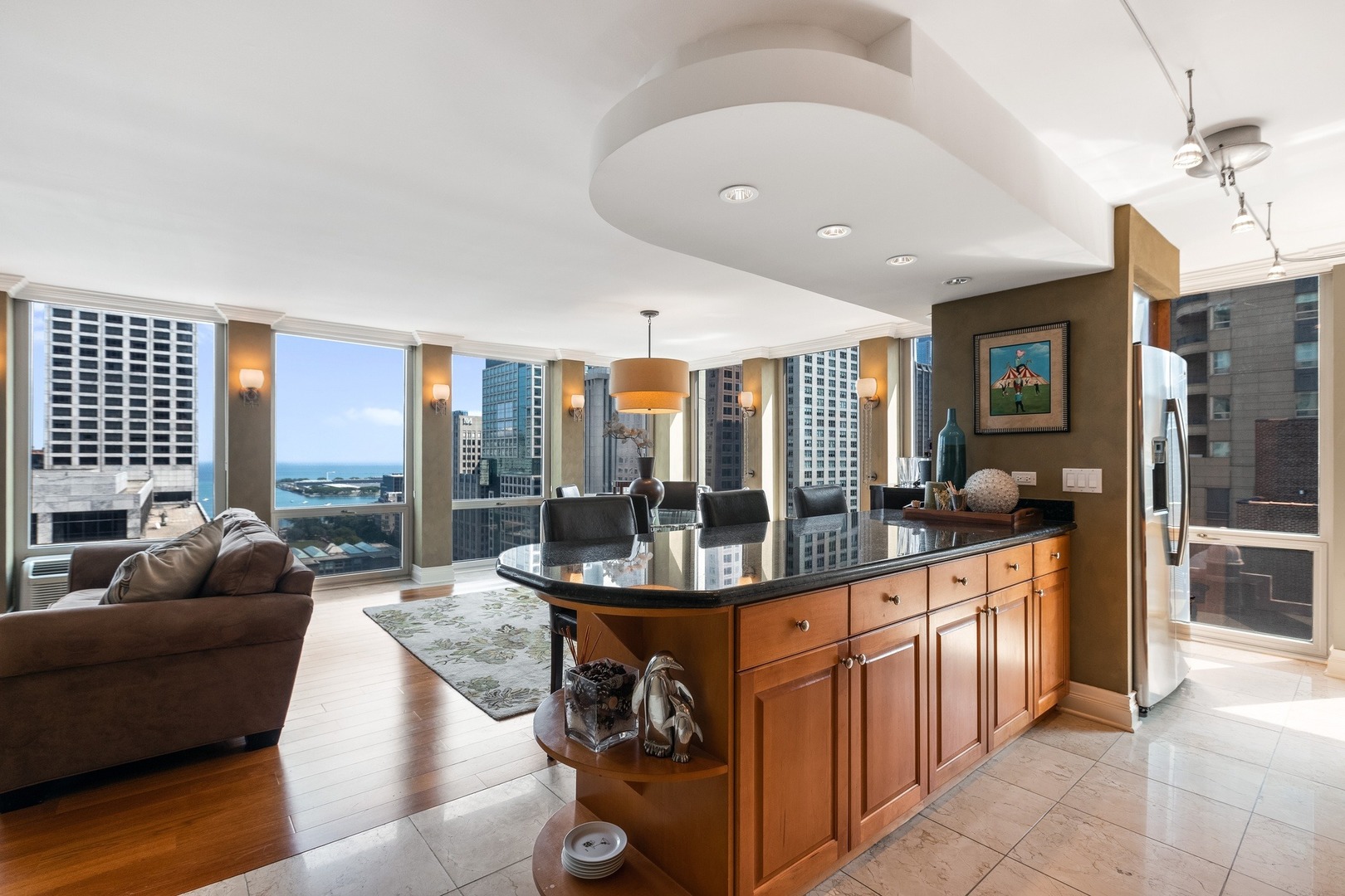 111 East Chestnut Street, Unit 25K Chicago, IL 60611 - Photo 12 of 28 a living room with stainless steel appliances granite countertop a couch a dining table and chairs
