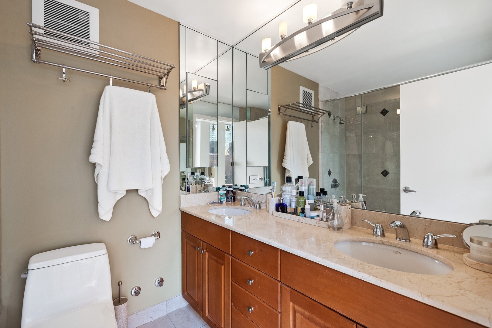 111 East Chestnut Street, Unit 25K Chicago, IL 60611 - Photo 14 of 28 a bathroom with a double vanity sink mirror and toilet