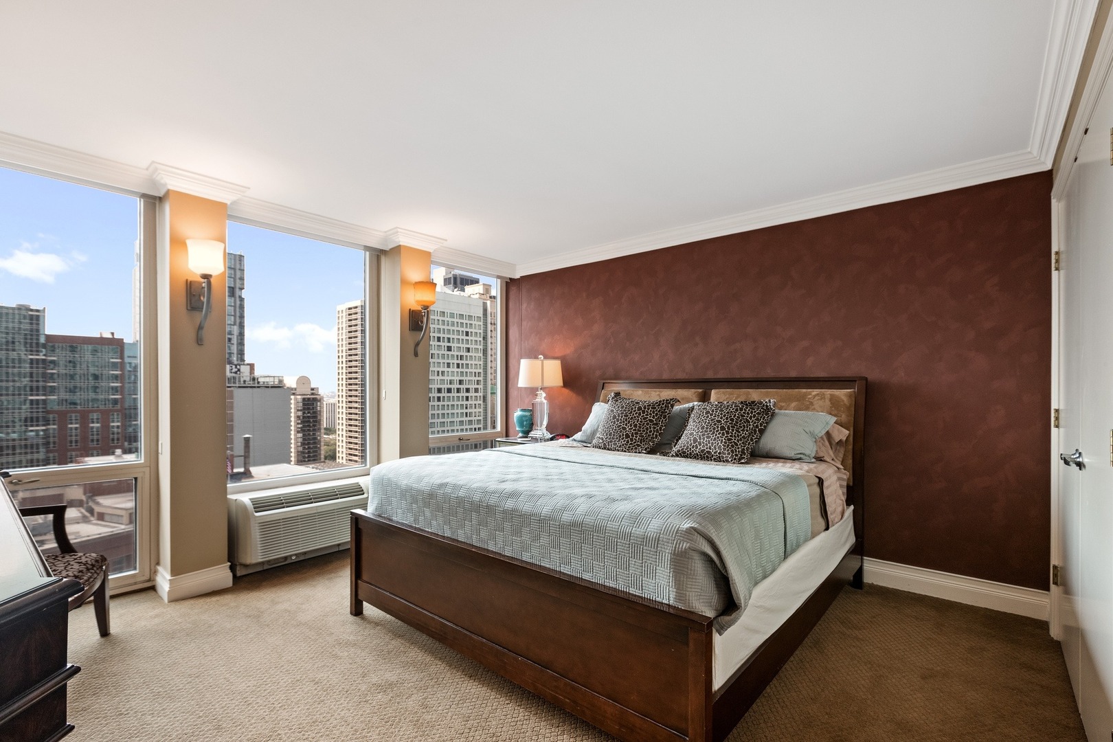 111 East Chestnut Street, Unit 25K Chicago, IL 60611 - Photo 15 of 28 a bedroom with a bed and glass window