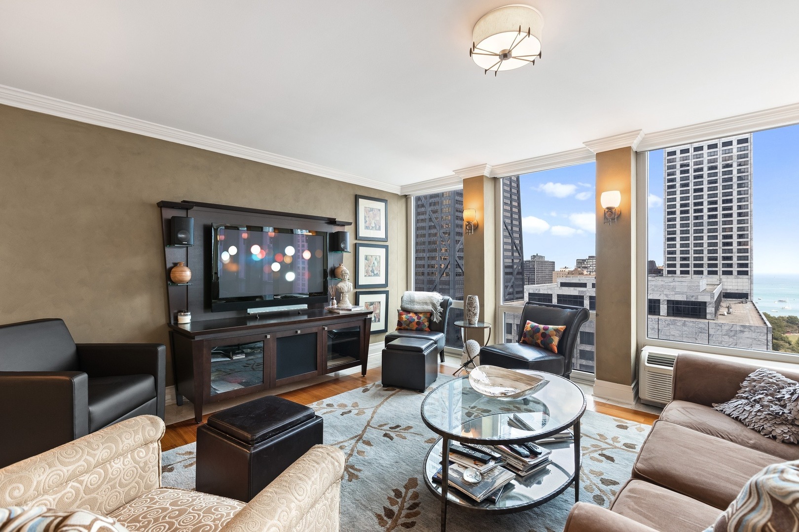 111 East Chestnut Street, Unit 25K Chicago, IL 60611 - Photo 3 of 28 a living room with furniture a flat screen tv and a large window