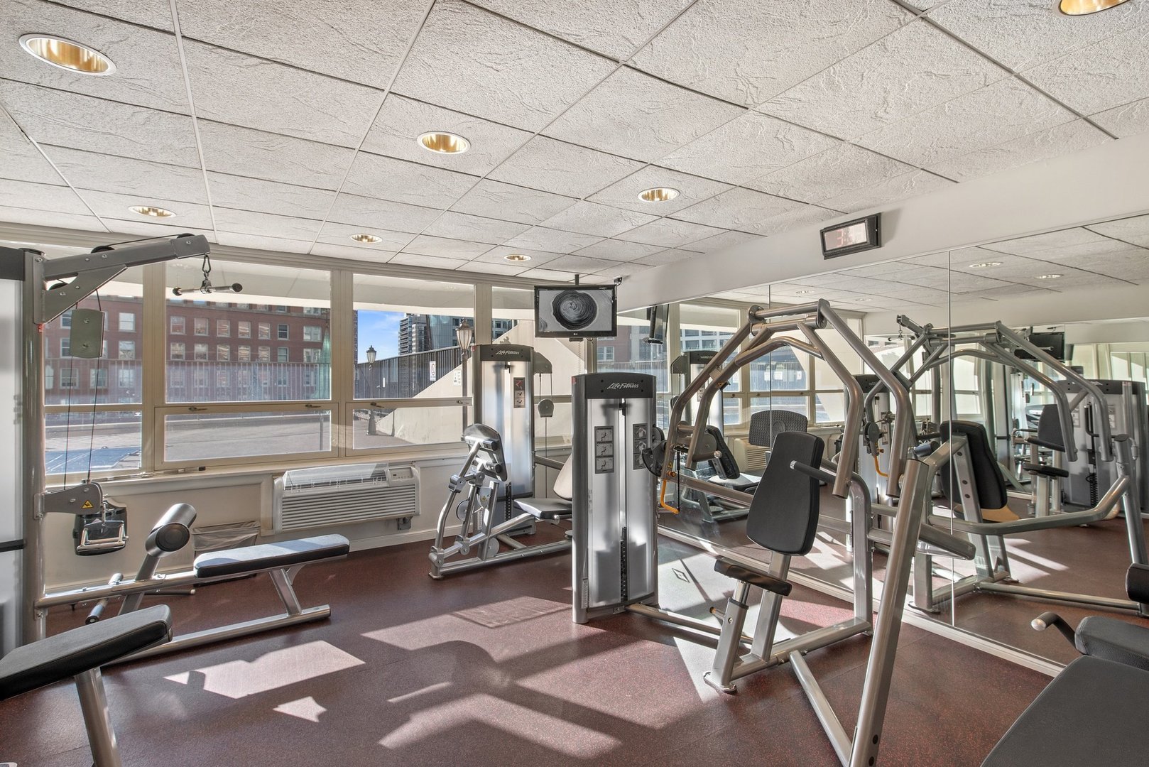 111 East Chestnut Street, Unit 25K Chicago, IL 60611 - Photo 27 of 28 a view of a room with gym equipment