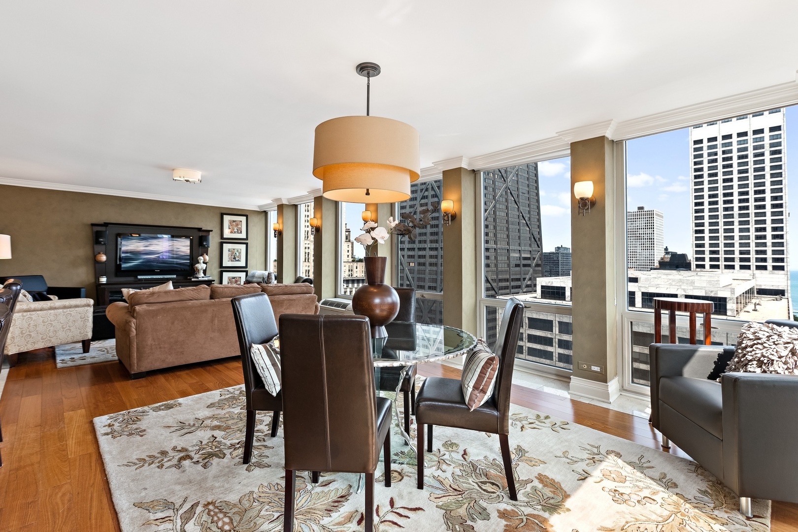 111 East Chestnut Street, Unit 25K Chicago, IL 60611 - Photo 7 of 28 a dining room with furniture a chandelier and wooden floor