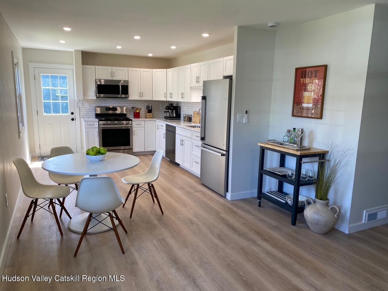 7 Park Circle High Falls, NY 12440 - Photo 25 of 31 a kitchen with stainless steel appliances a dining table chairs refrigerator and sink