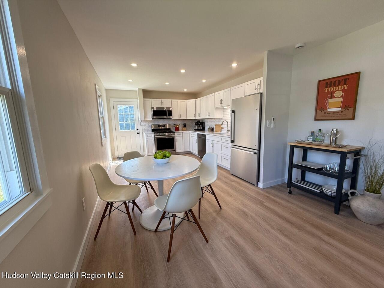 7 Park Circle High Falls, NY 12440 - Photo 27 of 31 a kitchen with stainless steel appliances a dining table chairs and refrigerator