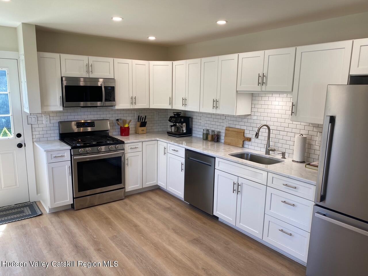 7 Park Circle High Falls, NY 12440 - Photo 28 of 31 a kitchen with granite countertop white cabinets and stainless steel appliances
