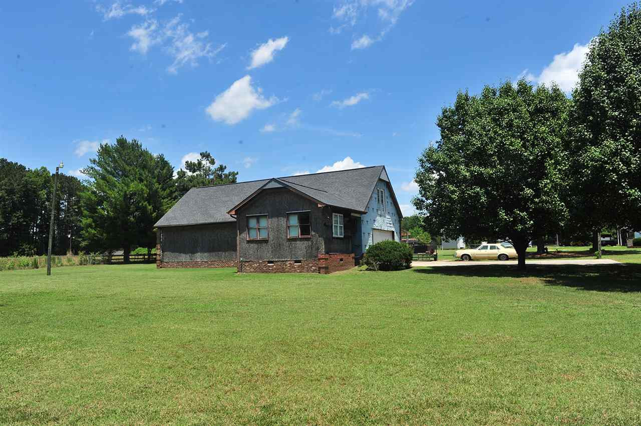 6909 Riley Hill Road Wendell, NC 27591 - Photo 2 of 12 View from Riley Hill Rd. Construction is not complete and will not be completed by seller. Home is sold as is. Roof replaced in 2011. Interior is a shell for buyer to design walls where they want. The Well is dug and ready for new owner to run plumbing. Exterior Front