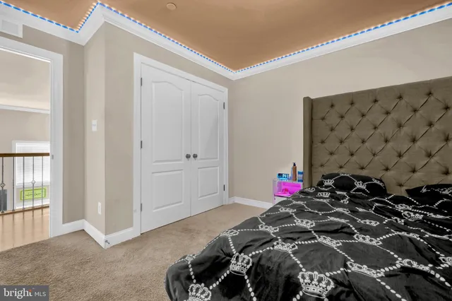 a bedroom with bed and a chandelier