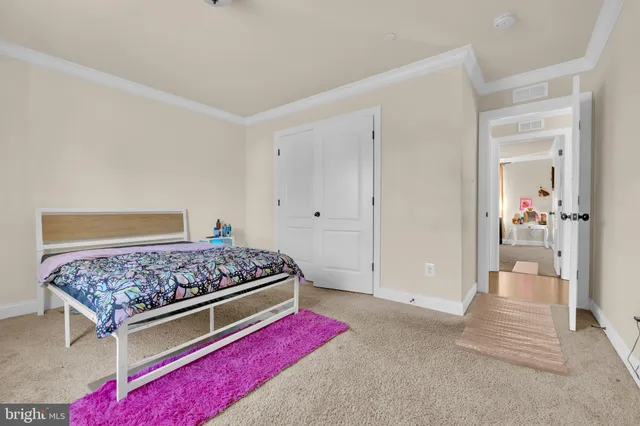a view of a hallway with wooden floor and stairs