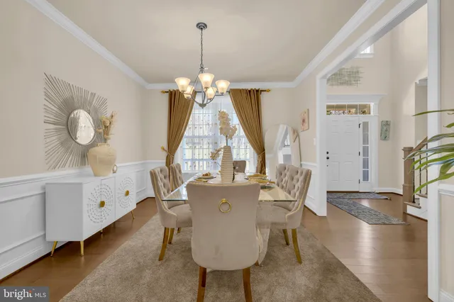 a view of a dining room with furniture wooden floor and chandelier