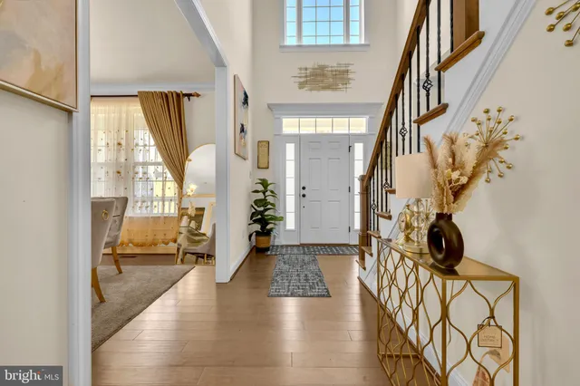 a view of staircase with lots of frames on wall and a table