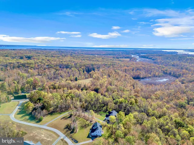 a spacious bathroom with a double vanity sink large mirror and bathtub