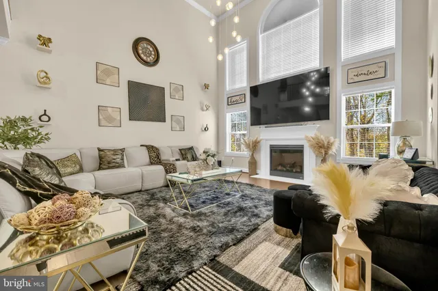 a kitchen with stainless steel appliances granite countertop a table chairs sink and cabinets