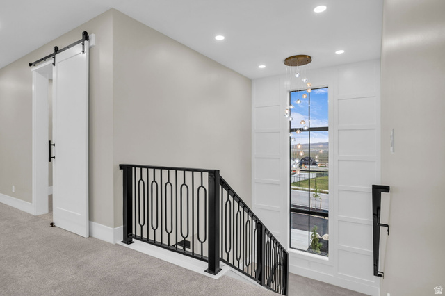 2828 Jojo Road Eagle Mountain, UT 84005 - Photo 33 of 63 Upper-level landing featuring a large window, a modern chandelier, and recessed lighting
