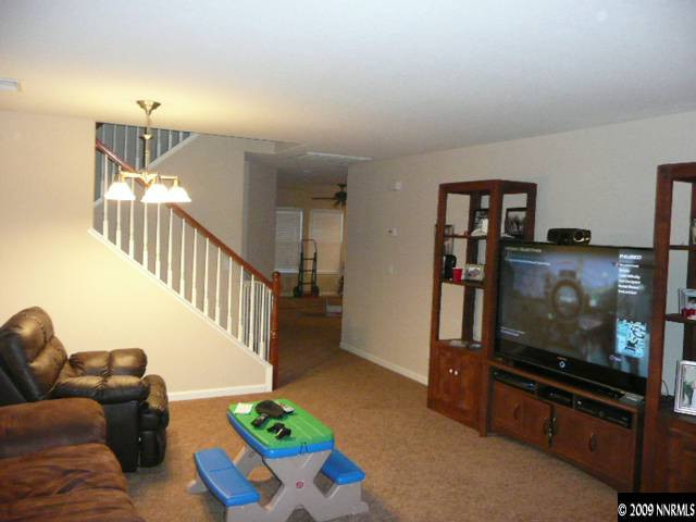 9010 Yeager Street Reno, NV 89506 - Photo 2 of 9 a living room with furniture and a flat screen tv