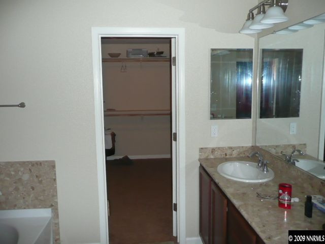 9010 Yeager Street Reno, NV 89506 - Photo 6 of 9 a bathroom with a sink vanity granite and a mirror