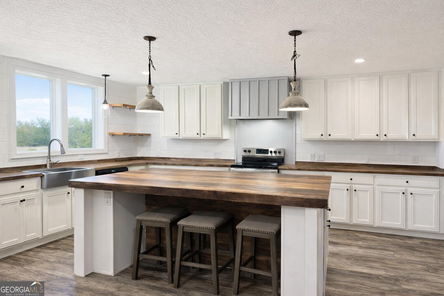 1900 Highway 212 Monticello, GA 31064 - Photo 3 of 20 a kitchen with stainless steel appliances granite countertop a table chairs sink and cabinets