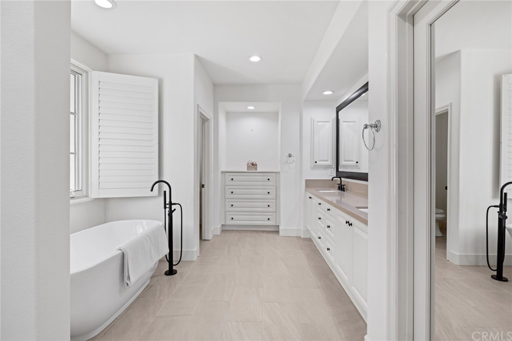 7 Hidden Pass Newport Coast, CA 92657 - Photo 13 of 30 a bathroom with a tub sink and mirror