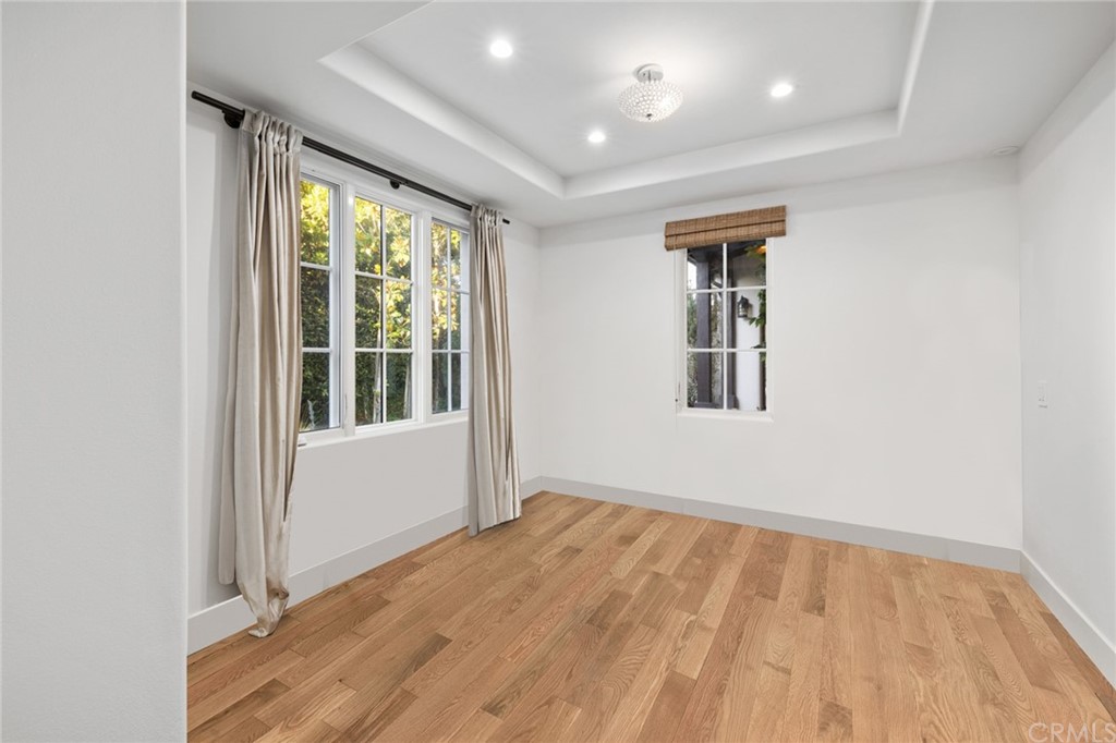 7 Hidden Pass Newport Coast, CA 92657 - Photo 20 of 30 an empty room with wooden floor and windows