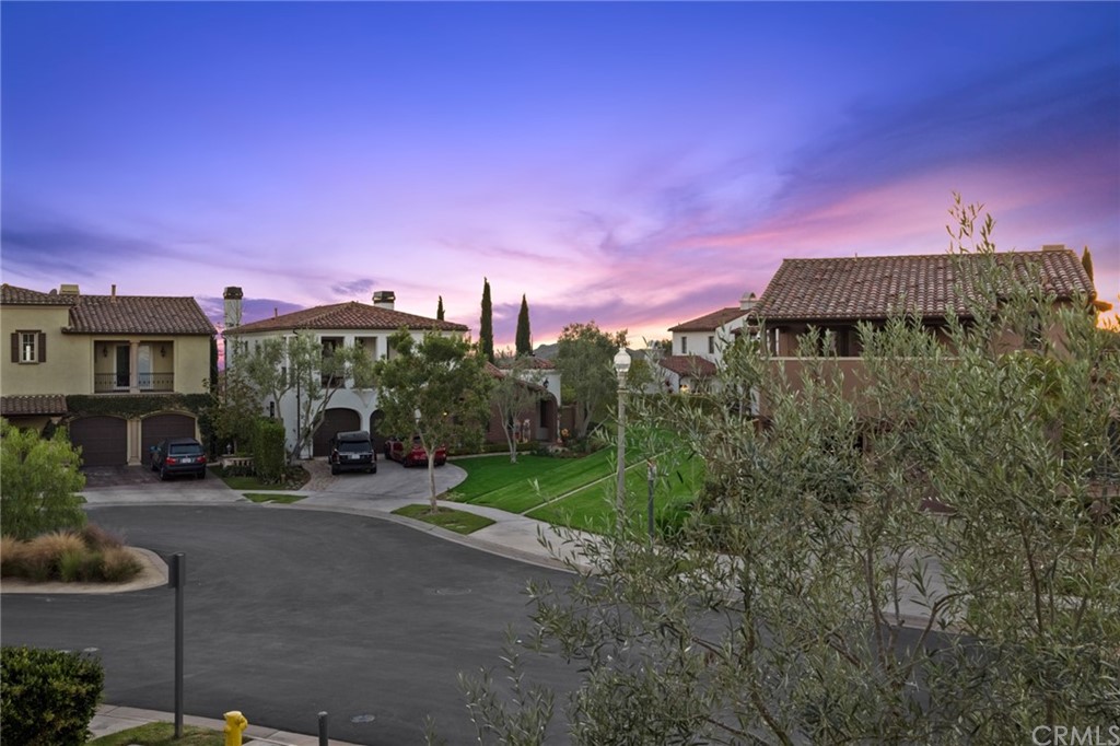 7 Hidden Pass Newport Coast, CA 92657 - Photo 25 of 30 a front view of a house with a yard and garage